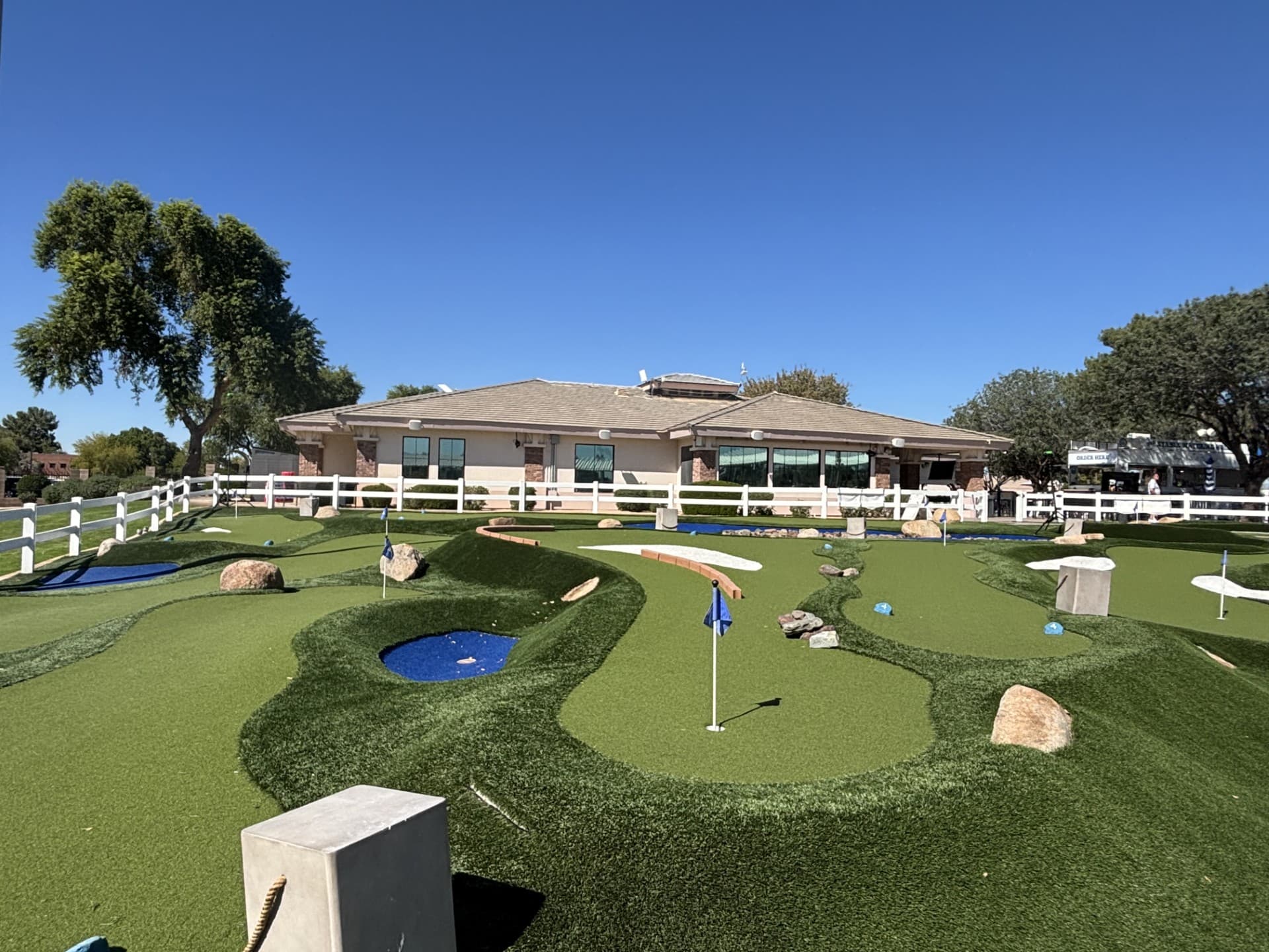 Miniature golf course with synthetic turf features